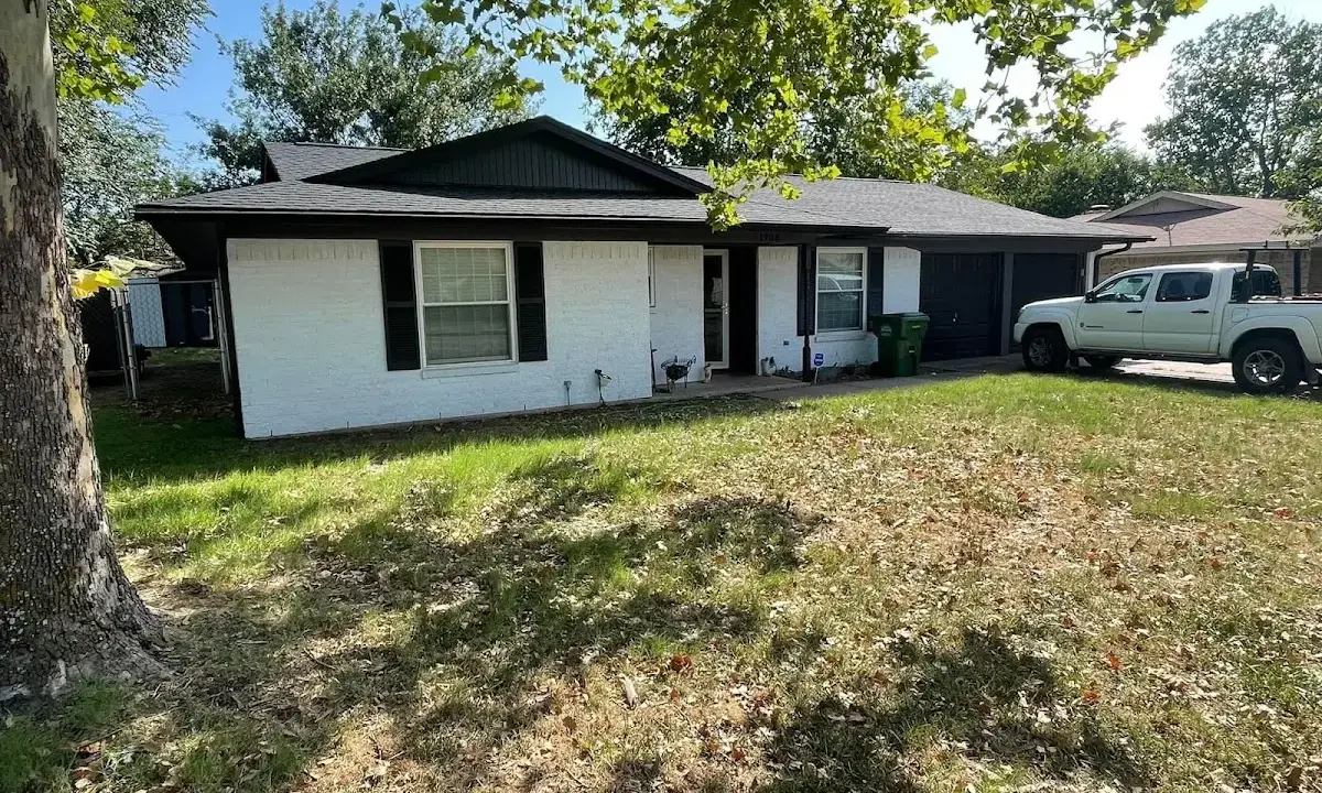 Professional roofing crew working on a residential roof in Plainville